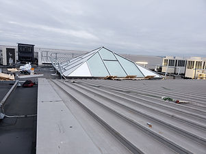 Large pyramid shaped glass skylight with some windows with reflective heat reduction window film and the others clear