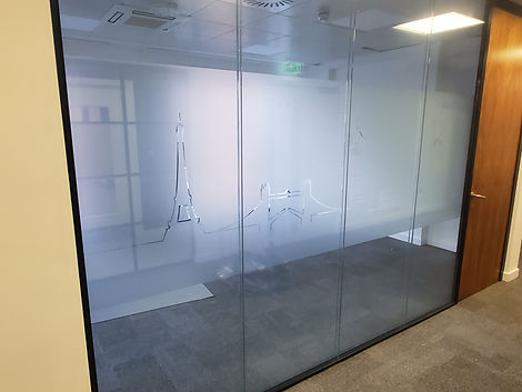 Frost banding with a city scape etched out of the frost on a glass partition wall