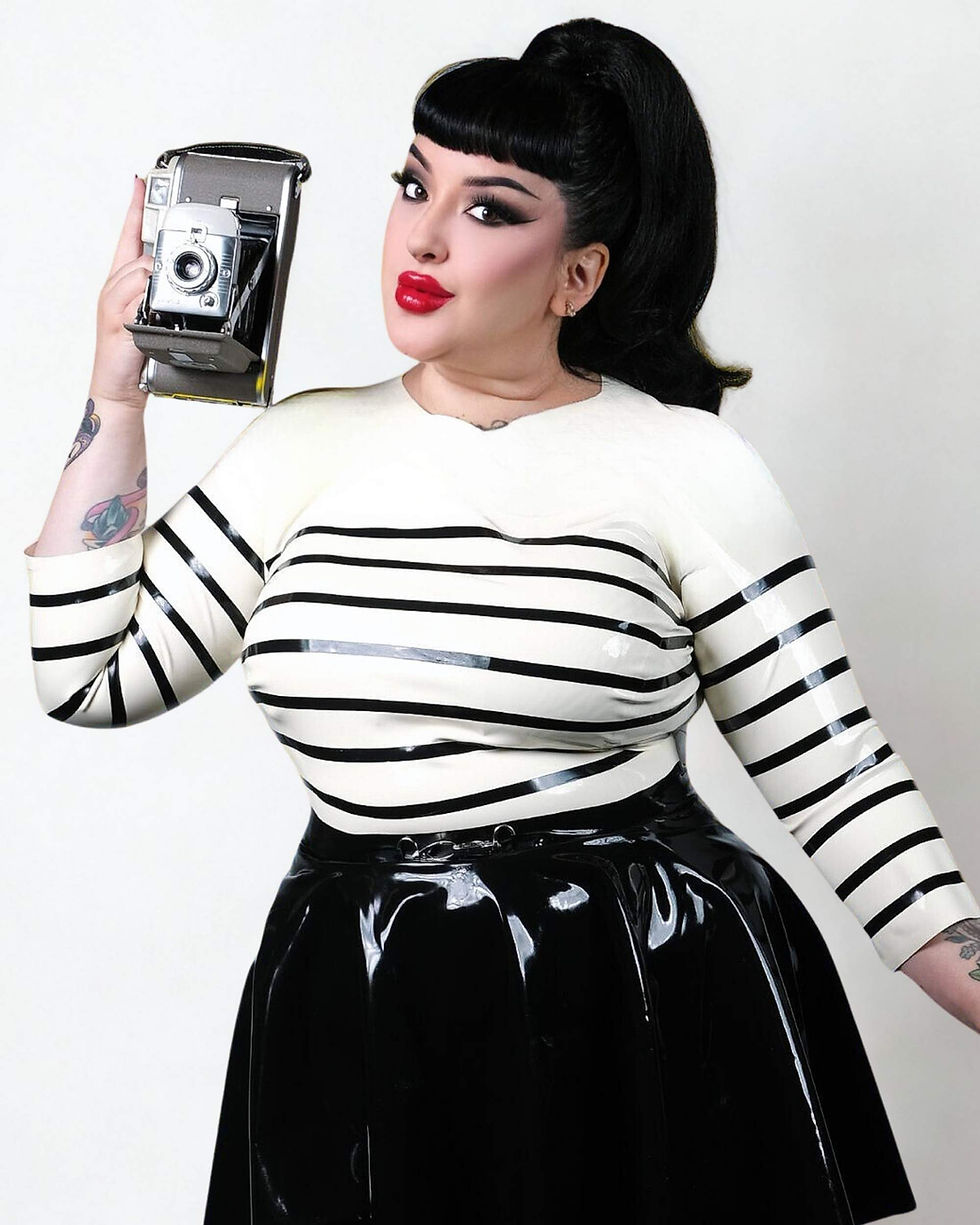 latex top showing 3/4 length sleeves and unique striped pattern to the front model styles with buckle front skating skirt