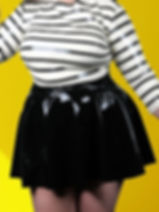 latex skating skirt with front buckle detailing worn with striped top