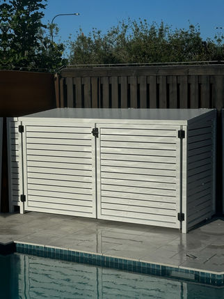 White closed storage cabinet with horizontal slats, near the pool area.