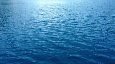 a-beautiful-high-angle-of-the-wide-lake-with-clear-blue-waters-making-gentle-waves-during-