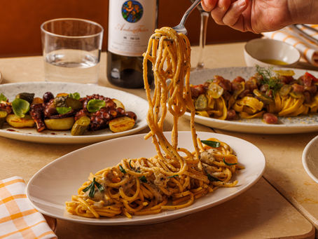 Customer enjoying a true Italian pasta and grilled octopus at Baccala