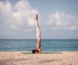 Young sport woman wearing sport suit practice yoga on the beach .Yoga is meditation and he