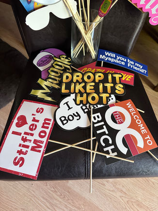 Bright neon 1980s sign prop for themed photo booth setup