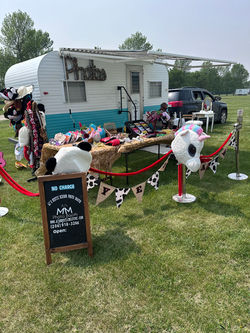 Rustic western backdrop and themed props arranged outside the Camper Photo Booth
