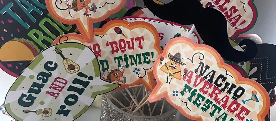 Fiesta‑themed handmade prop signs created for the Vintage Camper Photo Booth.