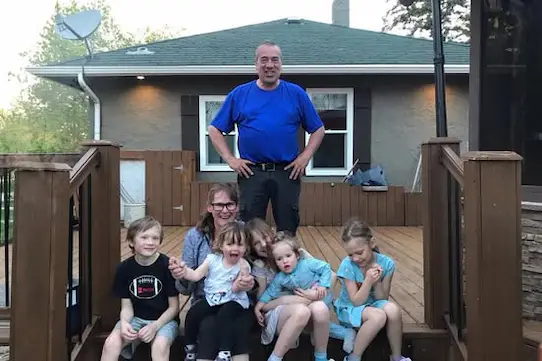 A heartwarming photo of AJ, her husband, and their six grandchildren, reflecting the family values at the heart of AJs Mystic Mirror.
