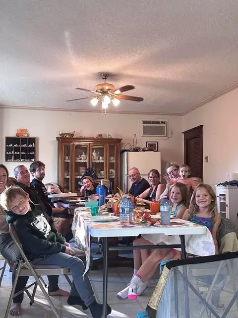 A heartwarming photo of AJ, her husband, and their six grandchildren, reflecting the family values at the heart of AJs Mystic Mirror."