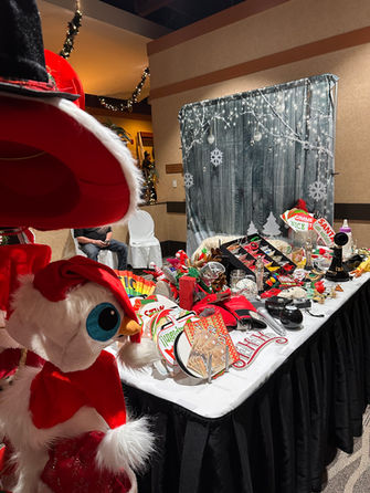 Photo booth props table with fun signs, glasses, and accessories at a Winnipeg event.