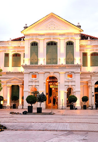 a white car parked in front of a large w