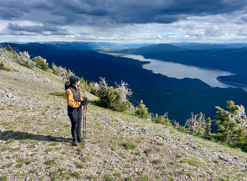 A hiker on the summit of Sheep Creek Peak