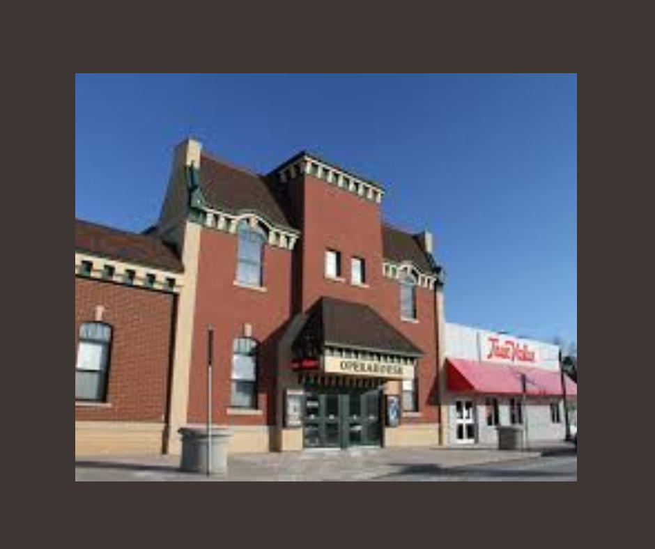 Front of a store front and an old fashion theater on Dewitt Main Street