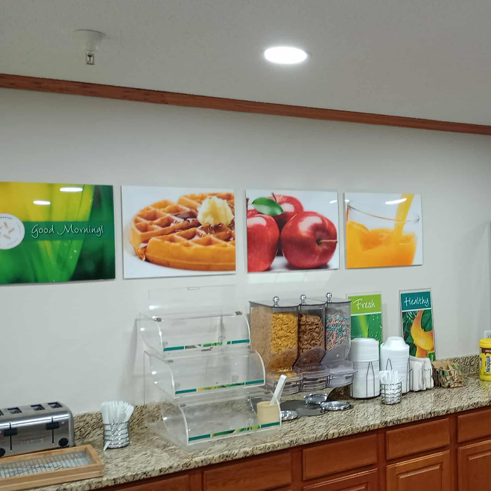 Signs of waffles, apples, orange juice. Free Hot Breakfast.