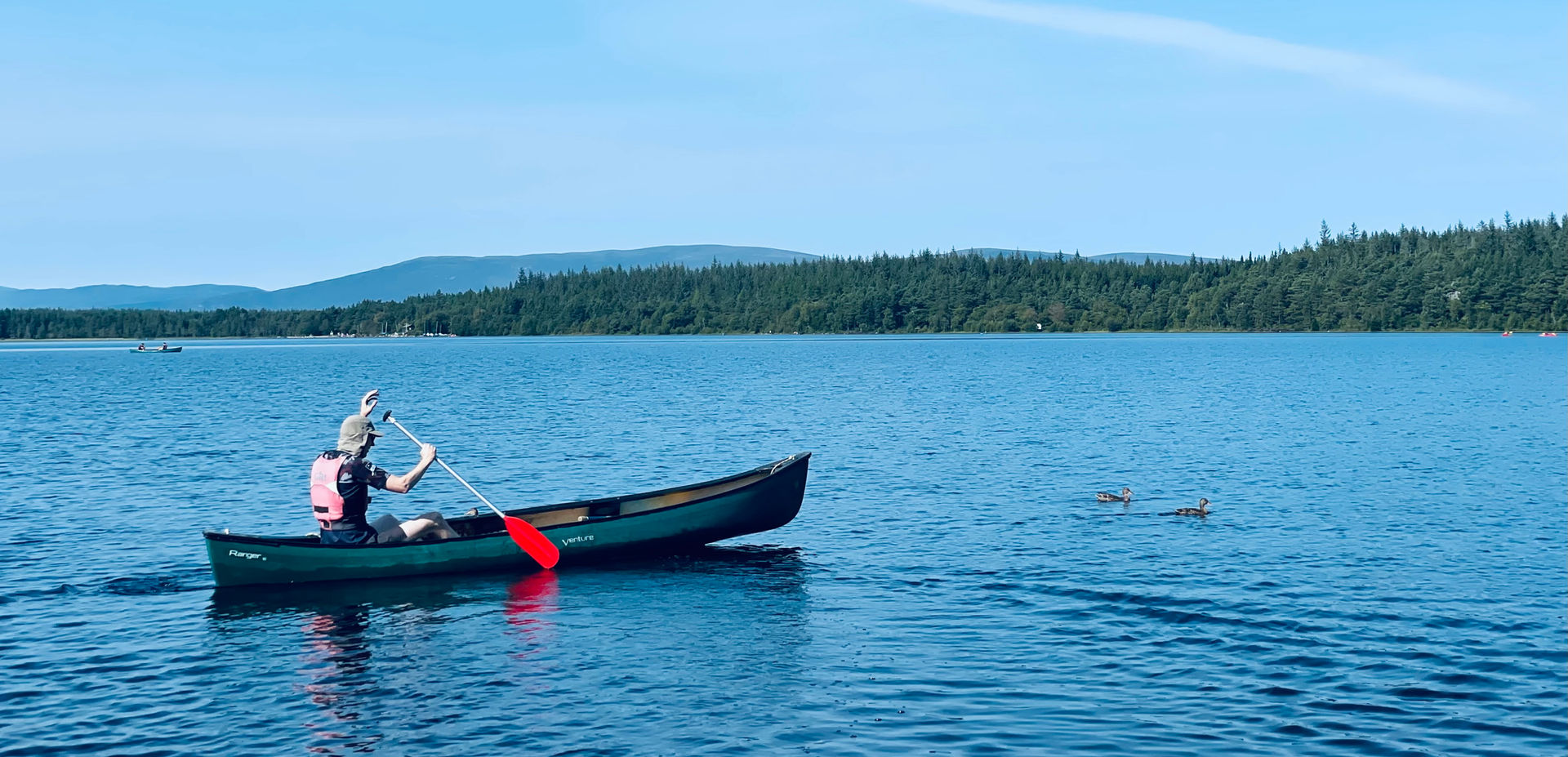 Canoer paddling on a calm lake
