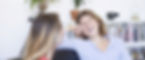 two-friends-talking-laughing-sofa-living-room-home.jpg