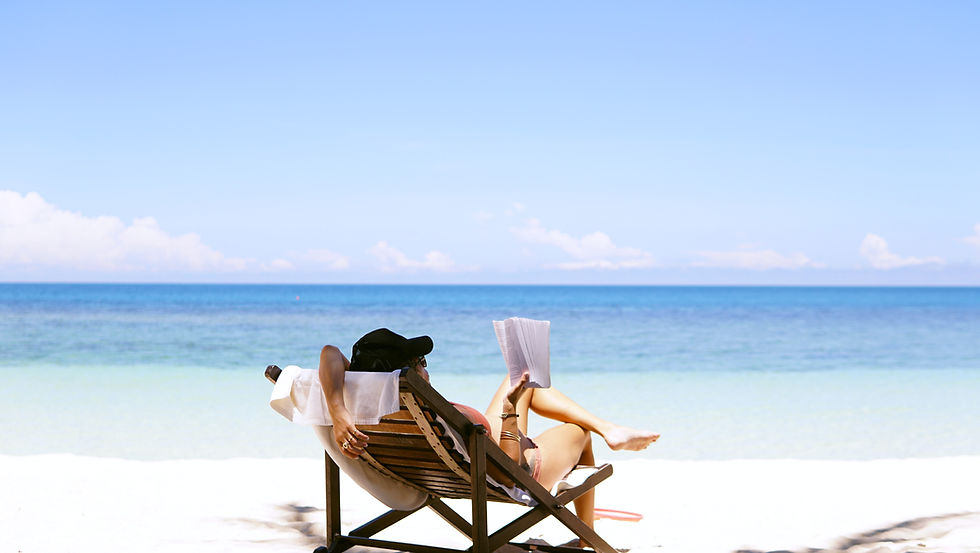 Person reading a book on the beach
