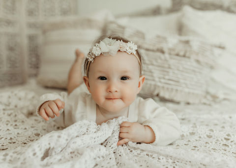 Elegant baby girl sitter milestone portrait with soft neutral textures and heirloom-inspired styling, photographed by Elsiebel Photography in Minneapolis.