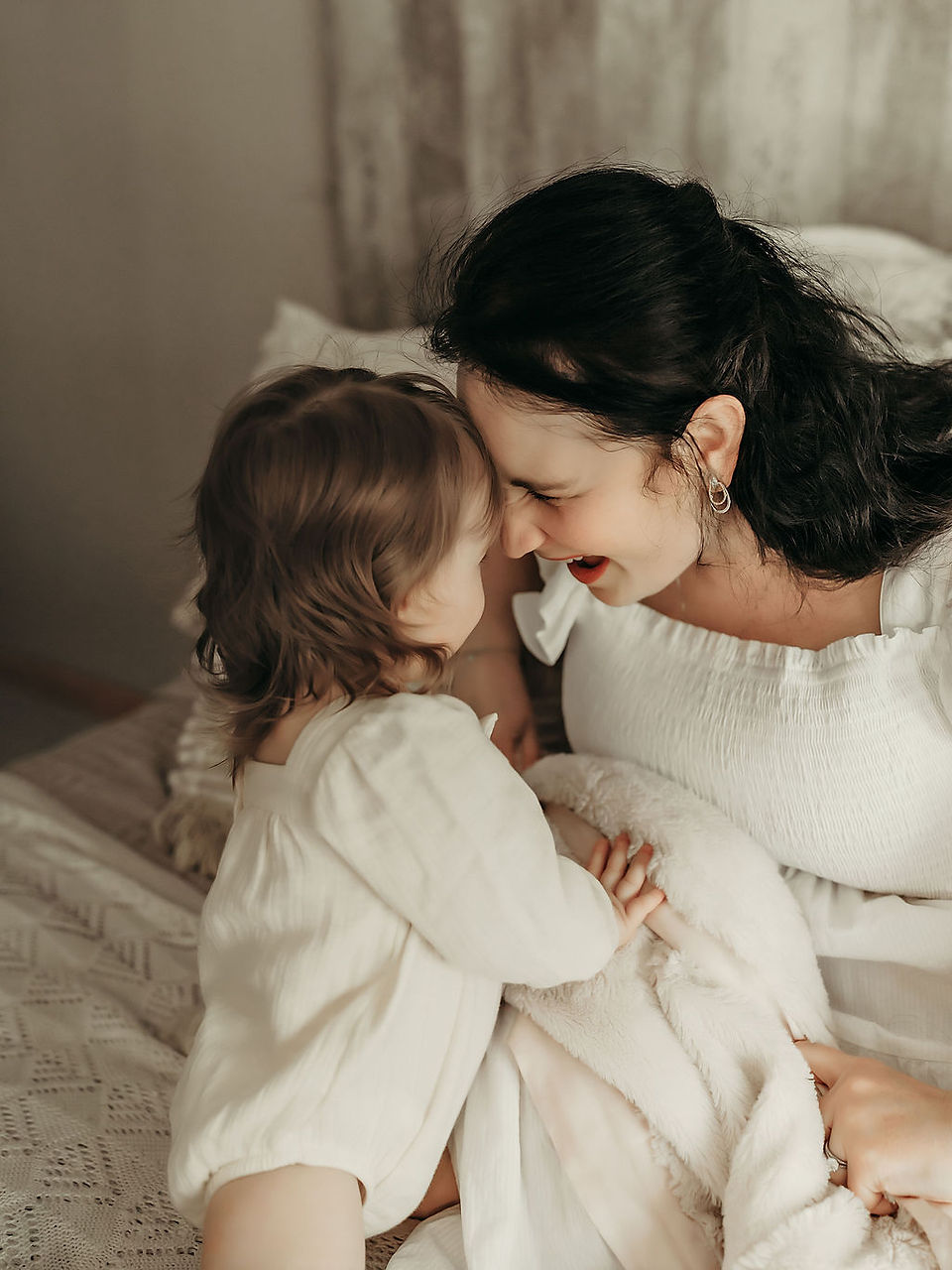 Mama and toddler sharing a sweet nose-to-nose moment during a timeless motherhood portrait by Elsiebel Photography in Medina, MN.