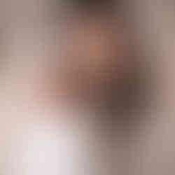 Full-length newborn pose with wrap and bow headband, studio newborn photography near Wayzata MN