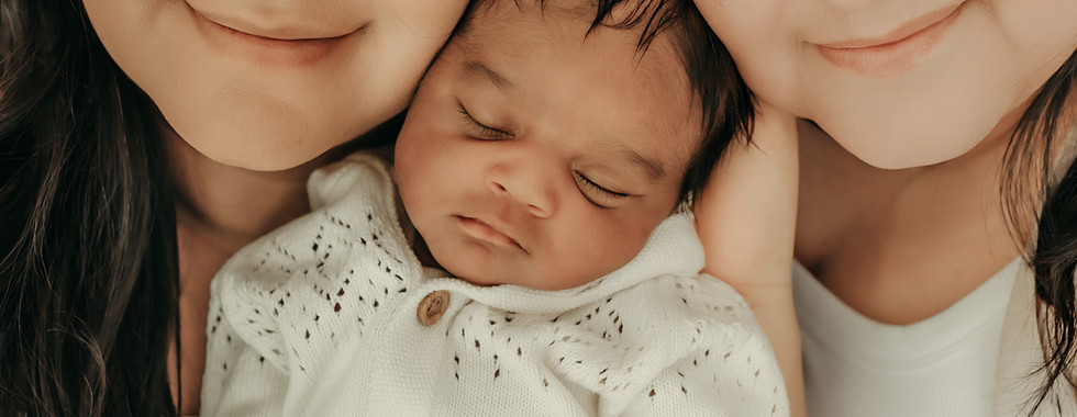 Mom cuddling newborn baby boy in a soft neutral family portrait at Elsiebel Photography near Minneapolis