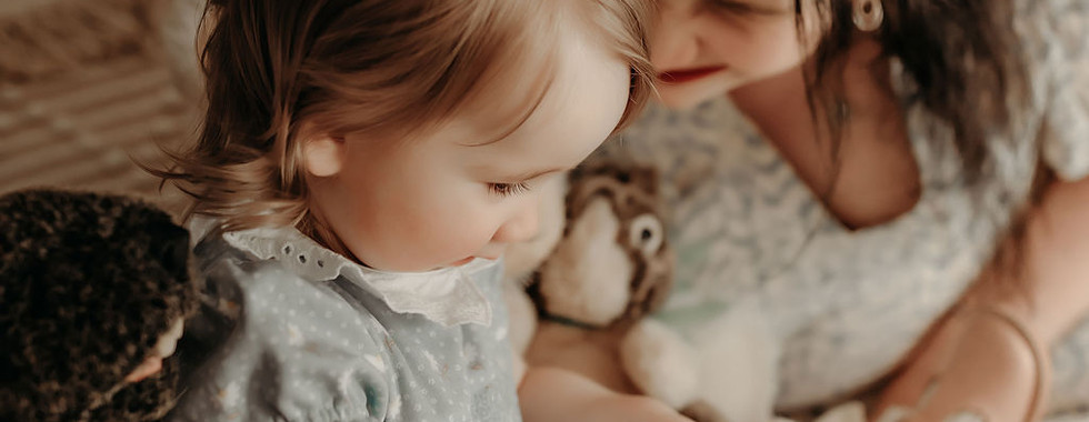 Mother embracing her one-year-old during a cozy motherhood portrait by Elsiebel Photography in Medina, Minnesota.