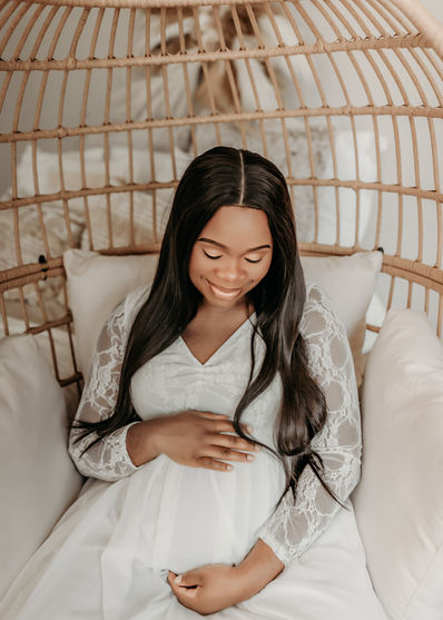 Expecting mother in white lace dress gently holding baby bump — fine-art maternity session by Elsiebel Photography in Burnsville MN