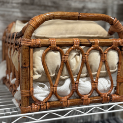Natural wicker newborn posing basket with soft neutral bedding used for timeless newborn portraits in Minneapolis.