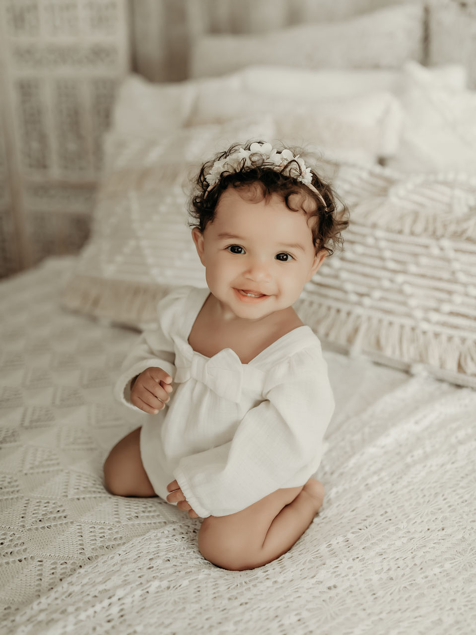 Baby girl sitting in a white outfit during a luxury milestone photography session at Elsiebel Photography serving Burnsville, Minneapolis, Edina, Eden Prairie, Maple Grove, and surrounding areas