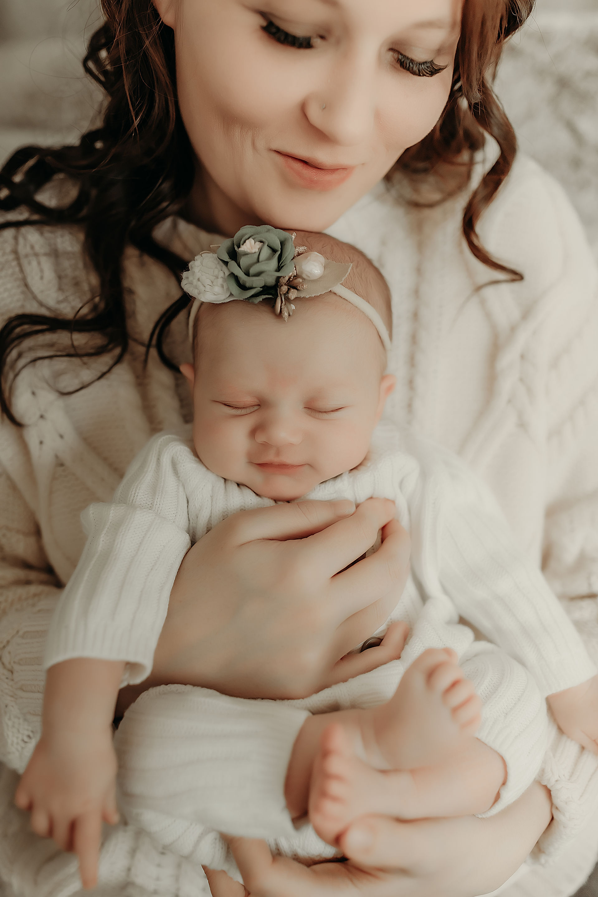 Baby girl resting on a neutral blanket during a Maple Grove newborn photography session.