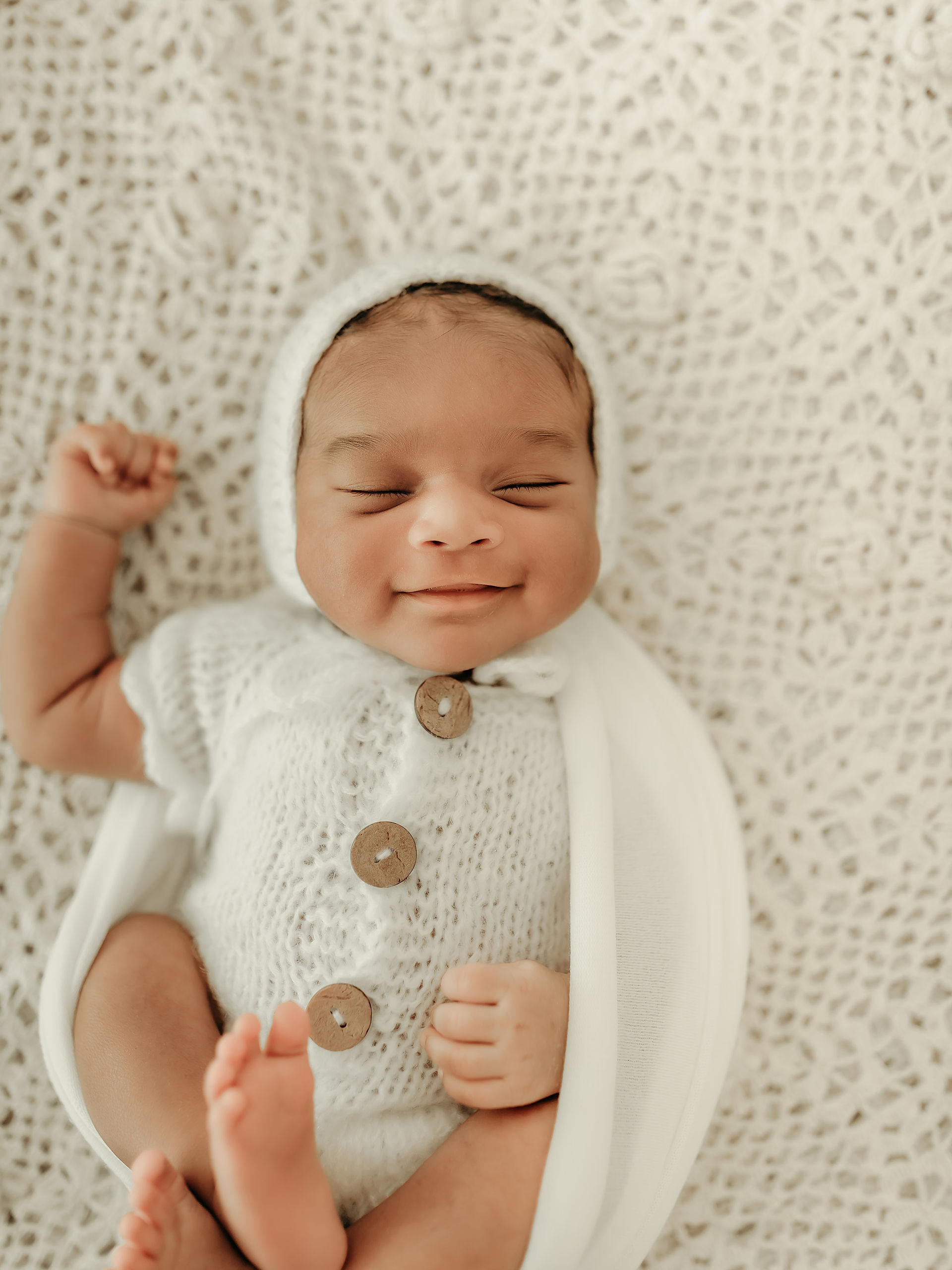 Newborn baby boy in a neutral knit outfit during a luxury newborn photography session in Maple Grove, Minnesota