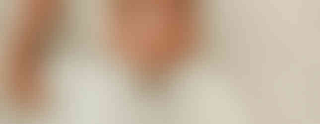 Newborn baby boy in a neutral knit outfit during a luxury newborn photography session in Maple Grove, Minnesota