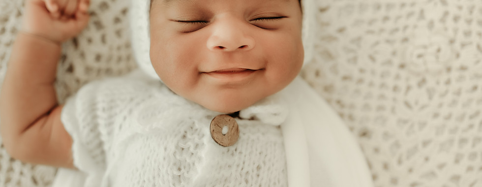 Newborn baby boy in a neutral knit outfit during a luxury newborn photography session in Maple Grove, Minnesota