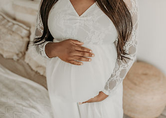 Close-up of hands on baby bump — intimate maternity detail photo by Elsiebel Photography in Burnsville MN.