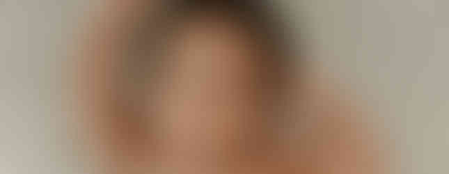 Smiling newborn baby boy with hands raised during a cozy newborn session in Maple Grove at Elsiebel Photography