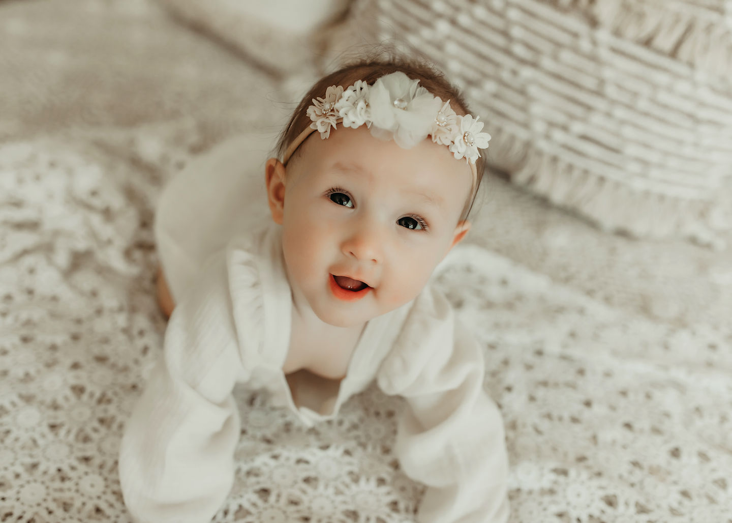 Luxury sitter milestone portrait of baby girl wearing delicate floral headband in a bright neutral Minneapolis baby photography studio by Elsiebel Photography.