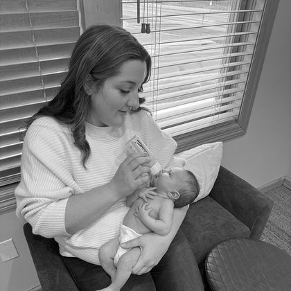 Mother soothing her newborn during a quiet moment inside Elsiebel Photography studio.