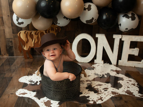 Luxury “My First Rodeo” cake smash photography in Burnsville, MN featuring a baby boy in cowboy hat with western props, Elsiebel Photography serving Apple Valley, Lakeville, and Edina families.