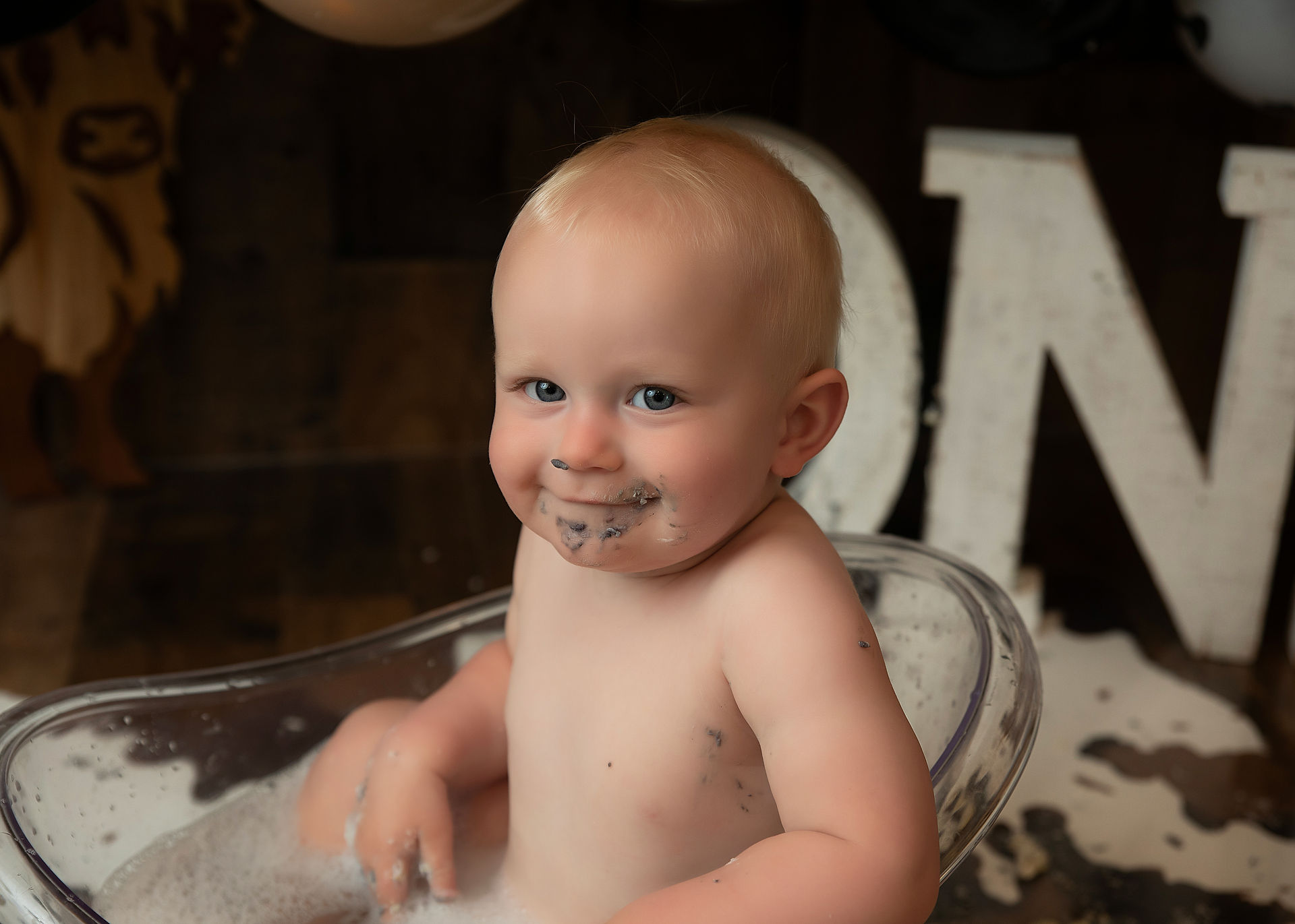 Cowboy cake smash photography with distressed barn wood backdrop in Apple Valley