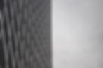 The background is a decorative grayscale side of a building, demonstrating innovative and unique, design/architecture.