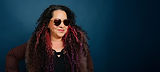 VO Artist Cia Court with long curly hair, pink highlights, heart sunglasses.