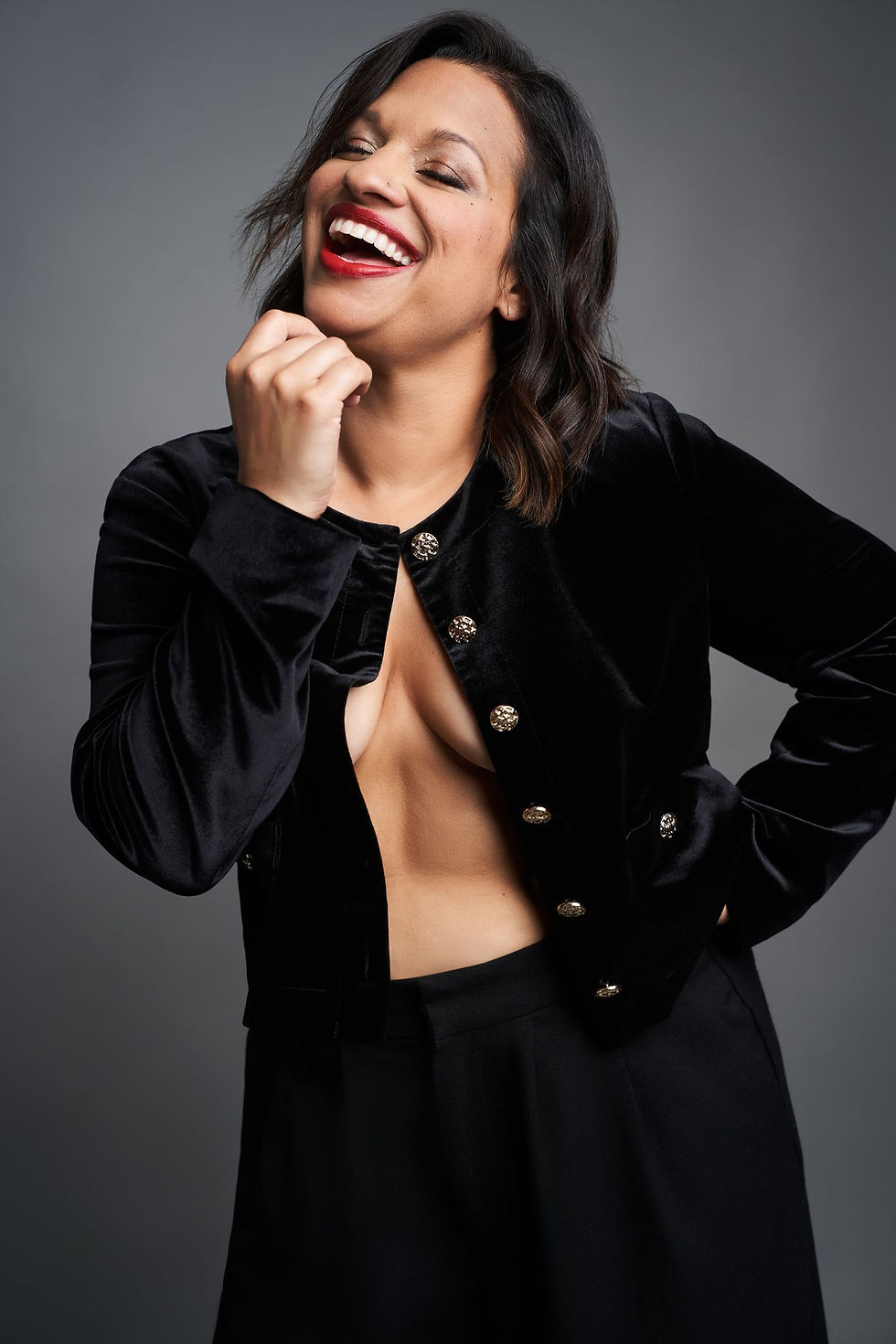 Writer and Performer Rati Gupta in a black velvet jacket laughing.