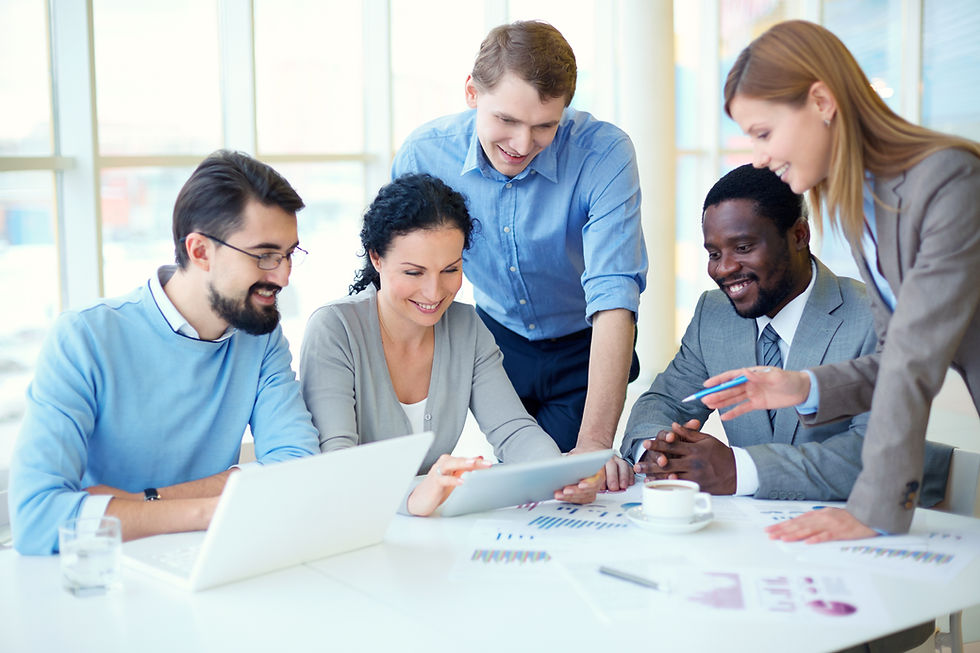 Five diverse business people collaborating around a table