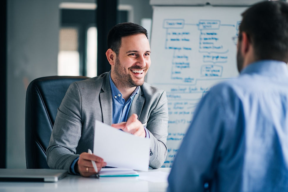 Smiling businessman reviewing documents with colleague