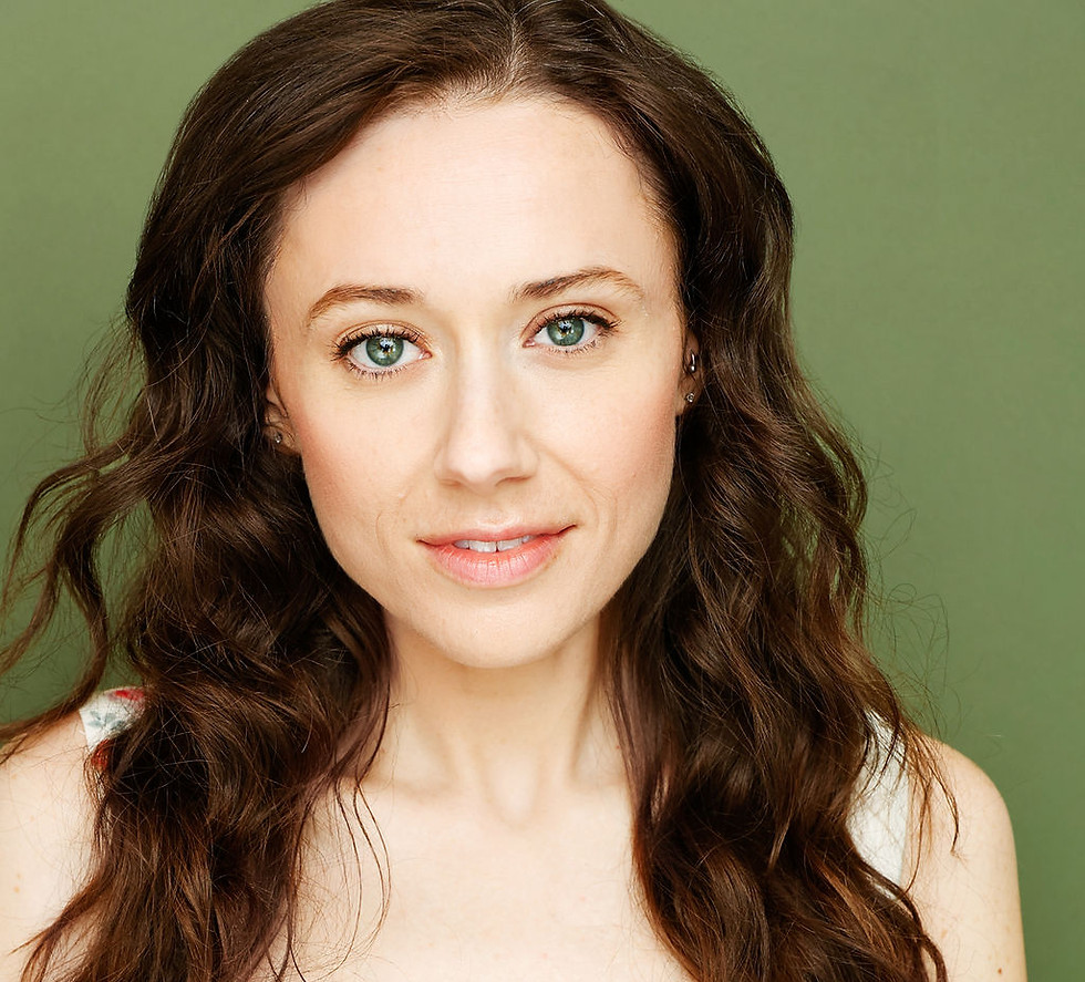 Headshot of Angie Campbell: brown wavy hair, floral top