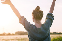 woman lifting hands in air