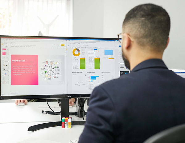 Digital marketer at GetFound Guru reviewing SEO strategy, keyword research, and website performance data on a desktop monitor.