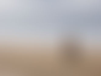 man walking on beach with fishing rod