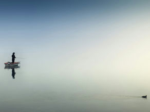 Man fishing on a boat on a lake