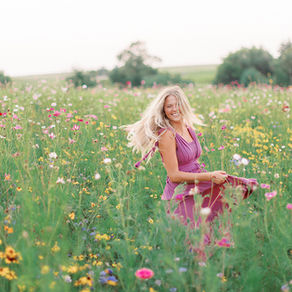 Senior girl twirling in a wildflower field in Lincoln